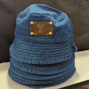 UPCYCLED AUTHENTIC LV LEATHER PATCH ON A DARK DENIM BUCKET HAT